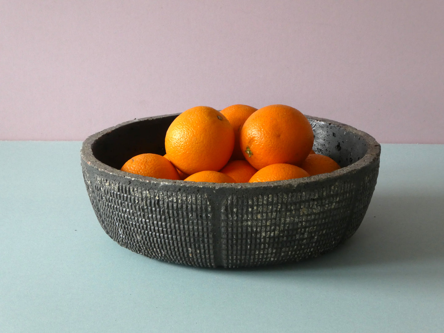 Handcrafted black concrete bowl with texture