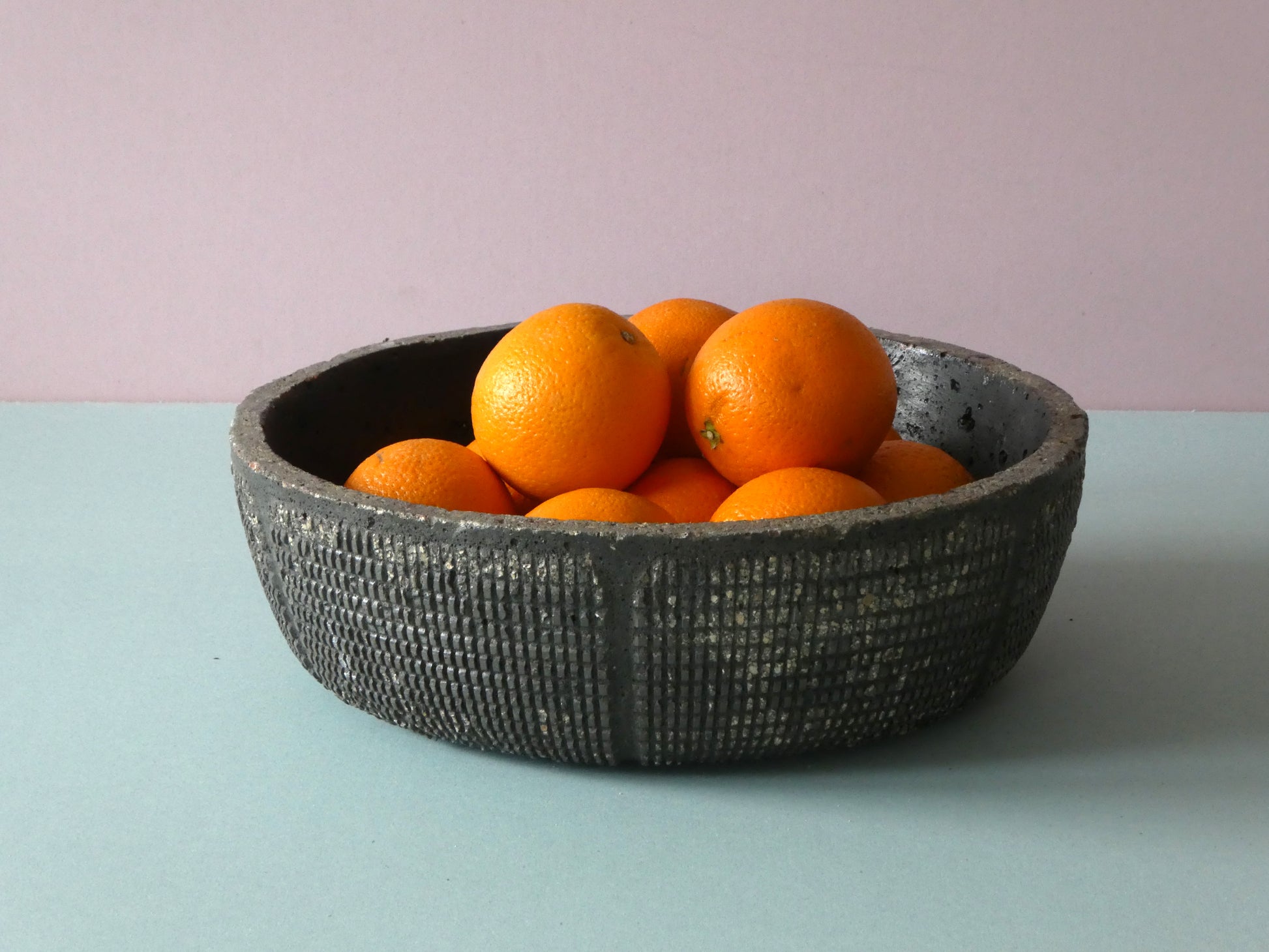 Handcrafted black concrete bowl with texture