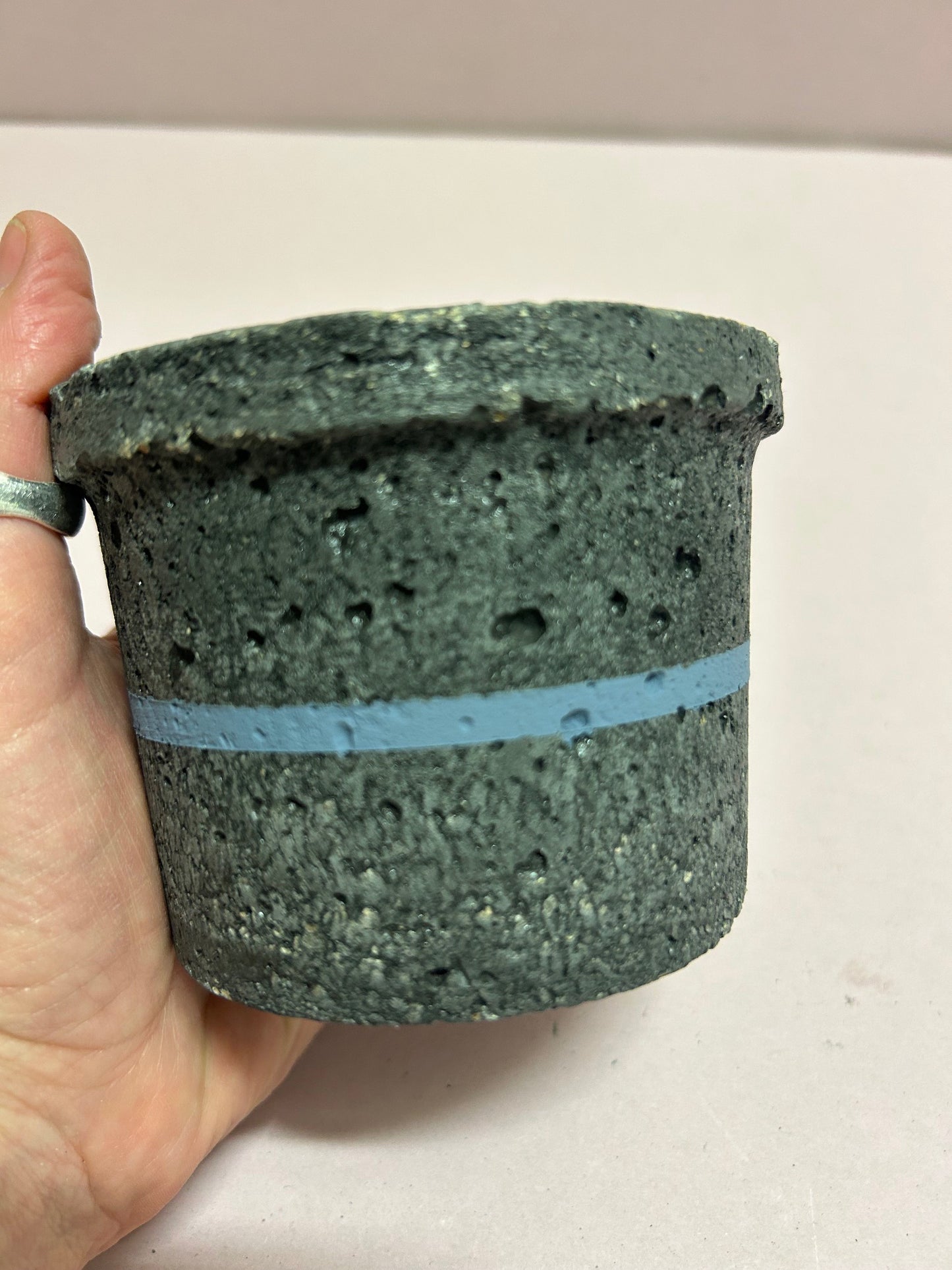 Black small concrete pot with blue stripe