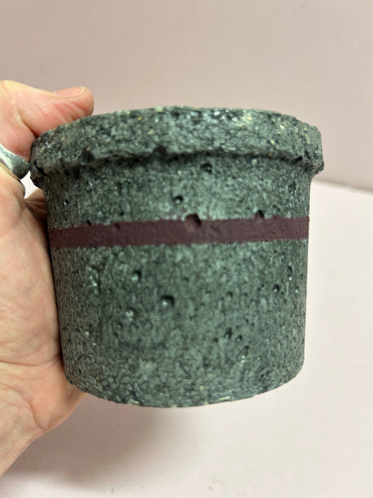 Black small concrete pot with mauve stripe