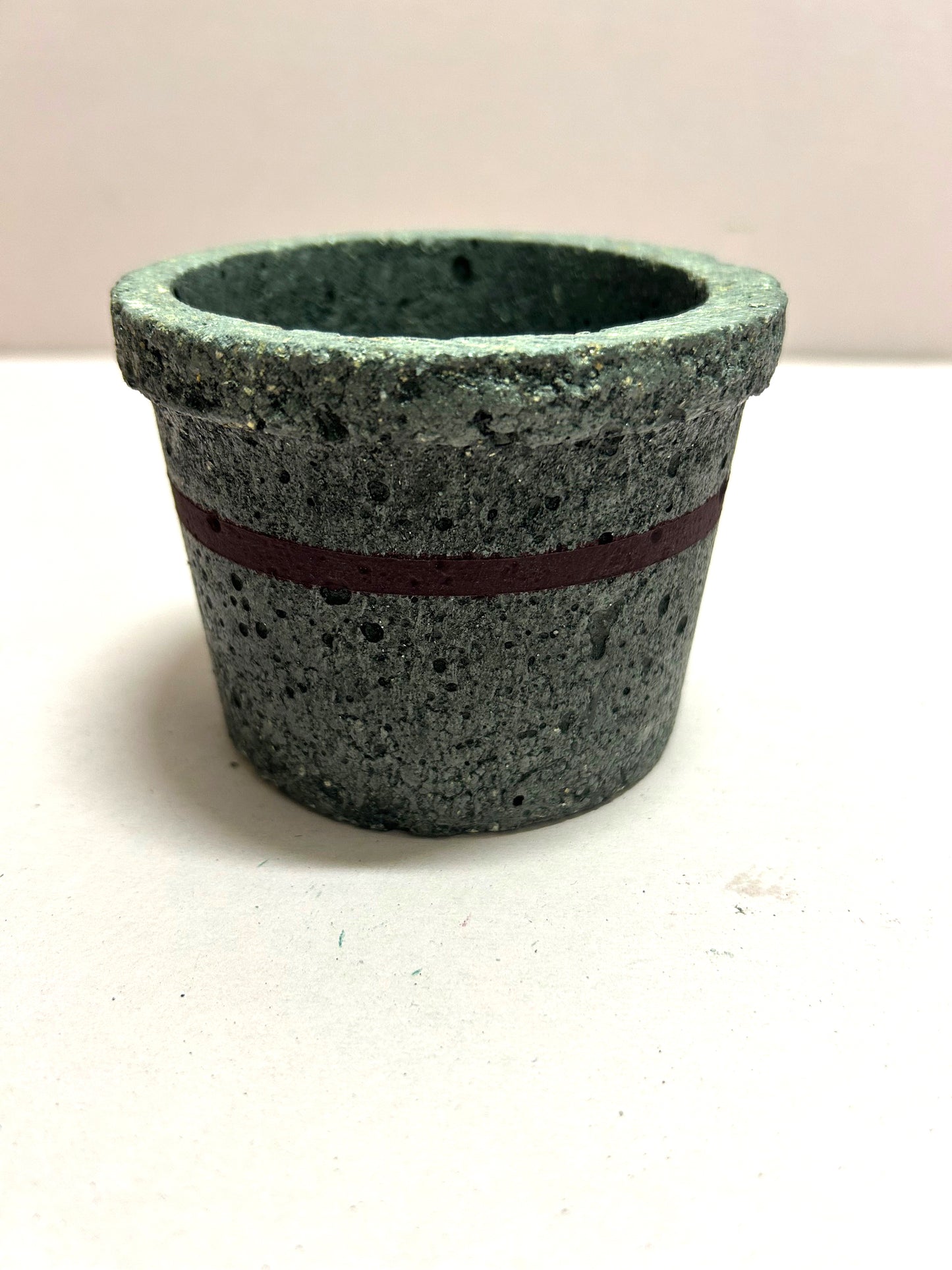 Black small concrete pot with mauve stripe