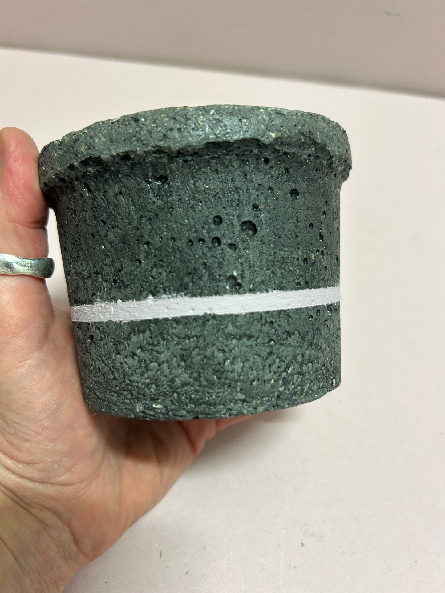 Black small concrete pot with pink stripe