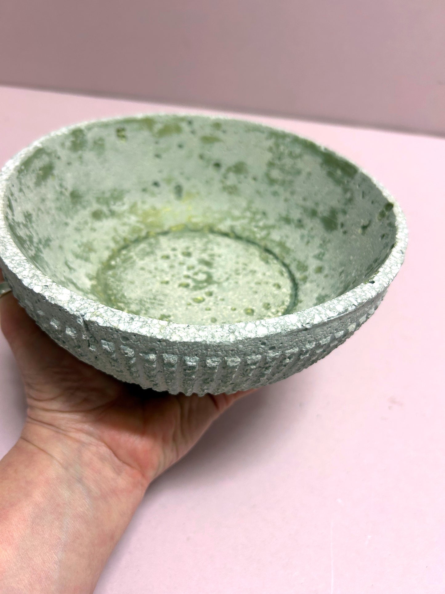 Small textured concrete bowl with green inside