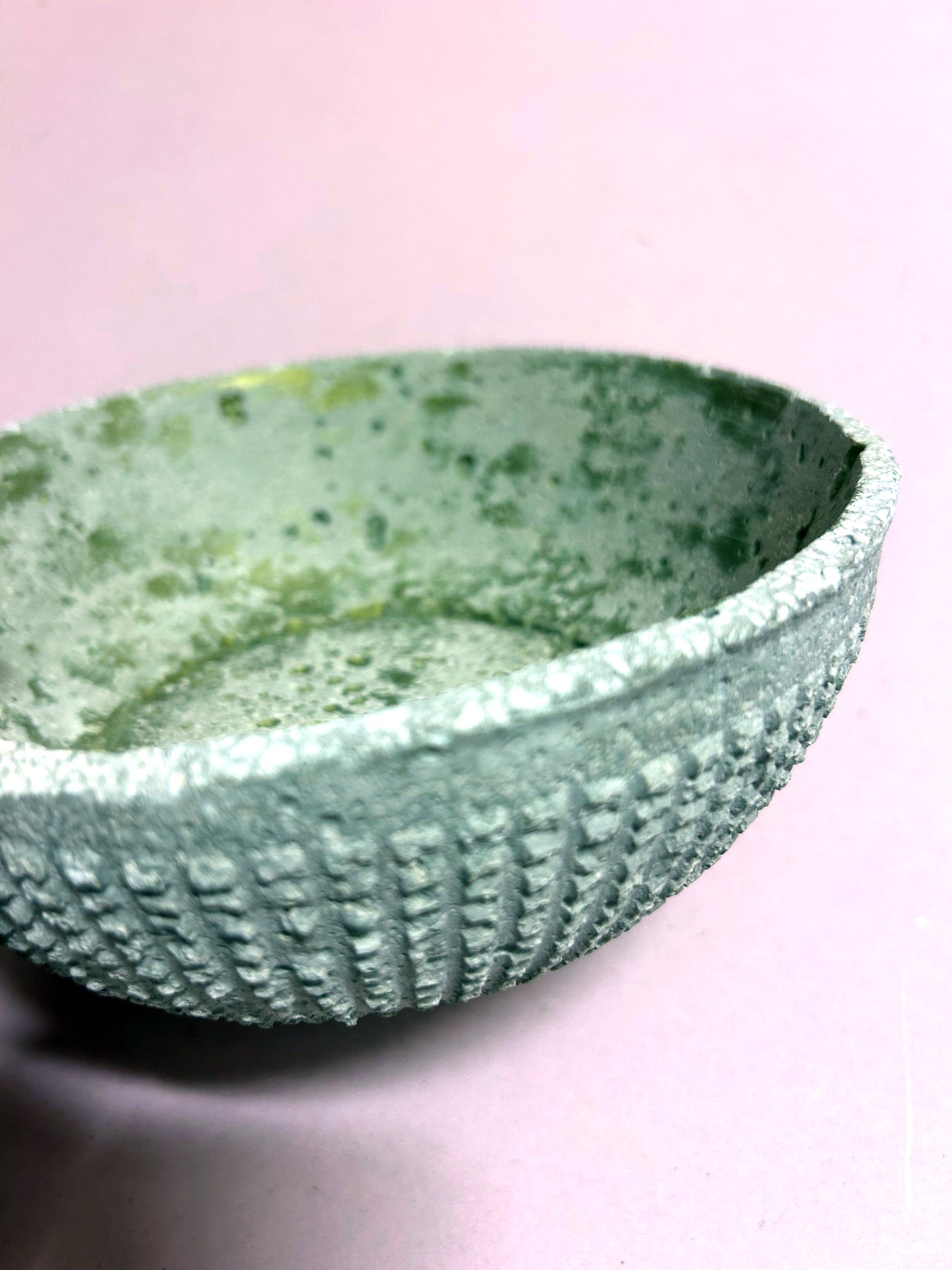 Small textured concrete bowl with green inside