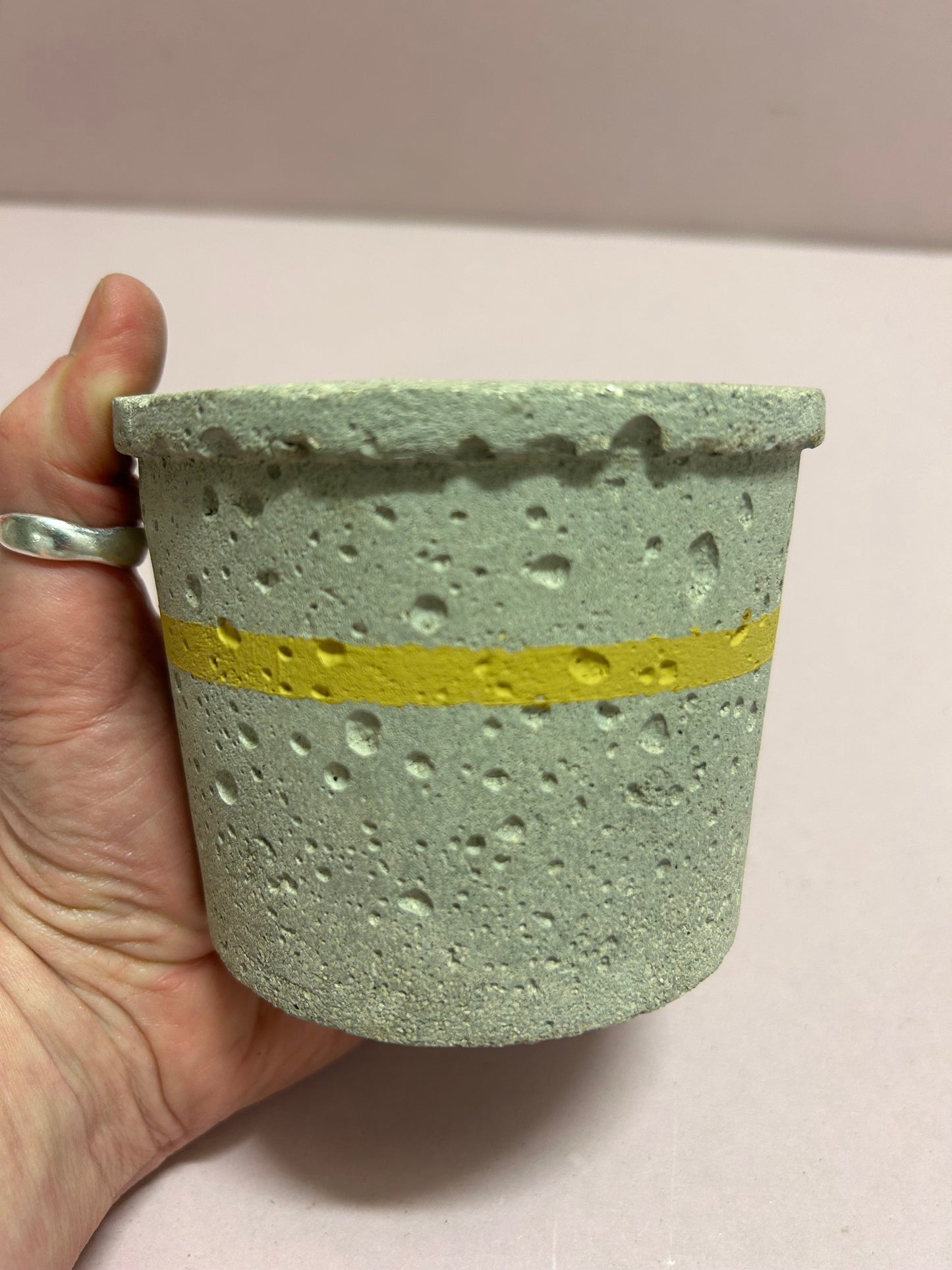Small natural pot with yellow stripe