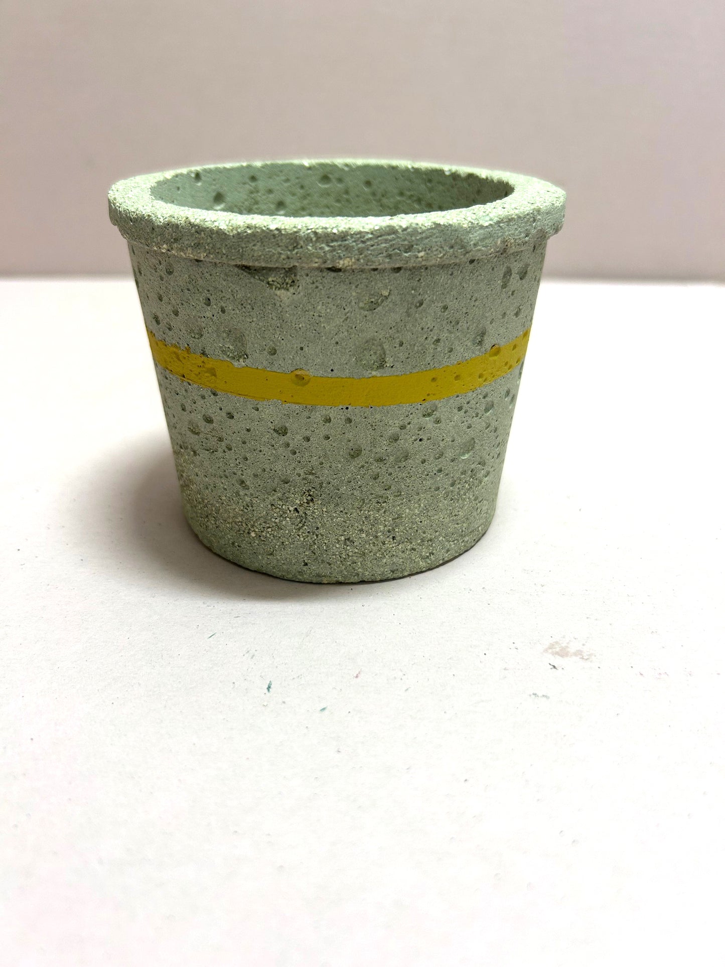 Small natural pot with yellow stripe